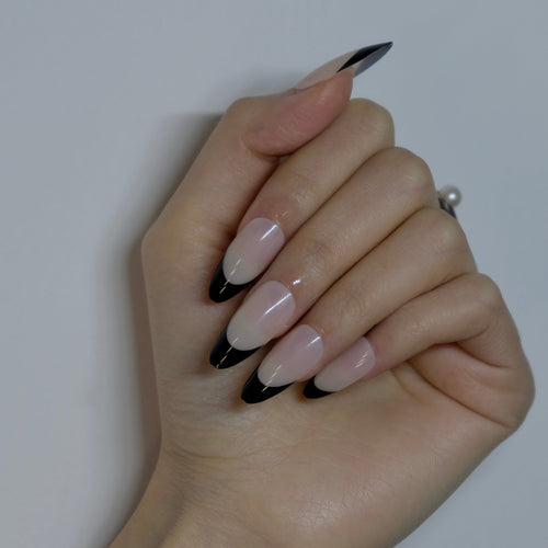 Hand with black and white nail design on a plain background